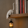 Black and white shelf-edge cat lantern figurines