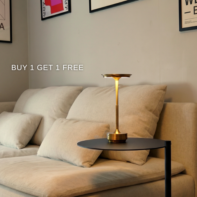 Gold rechargeable table lamp on a side table by a sofa