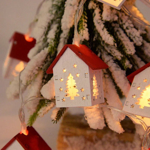 Close-up of a paper house light with tree and star cut-outs