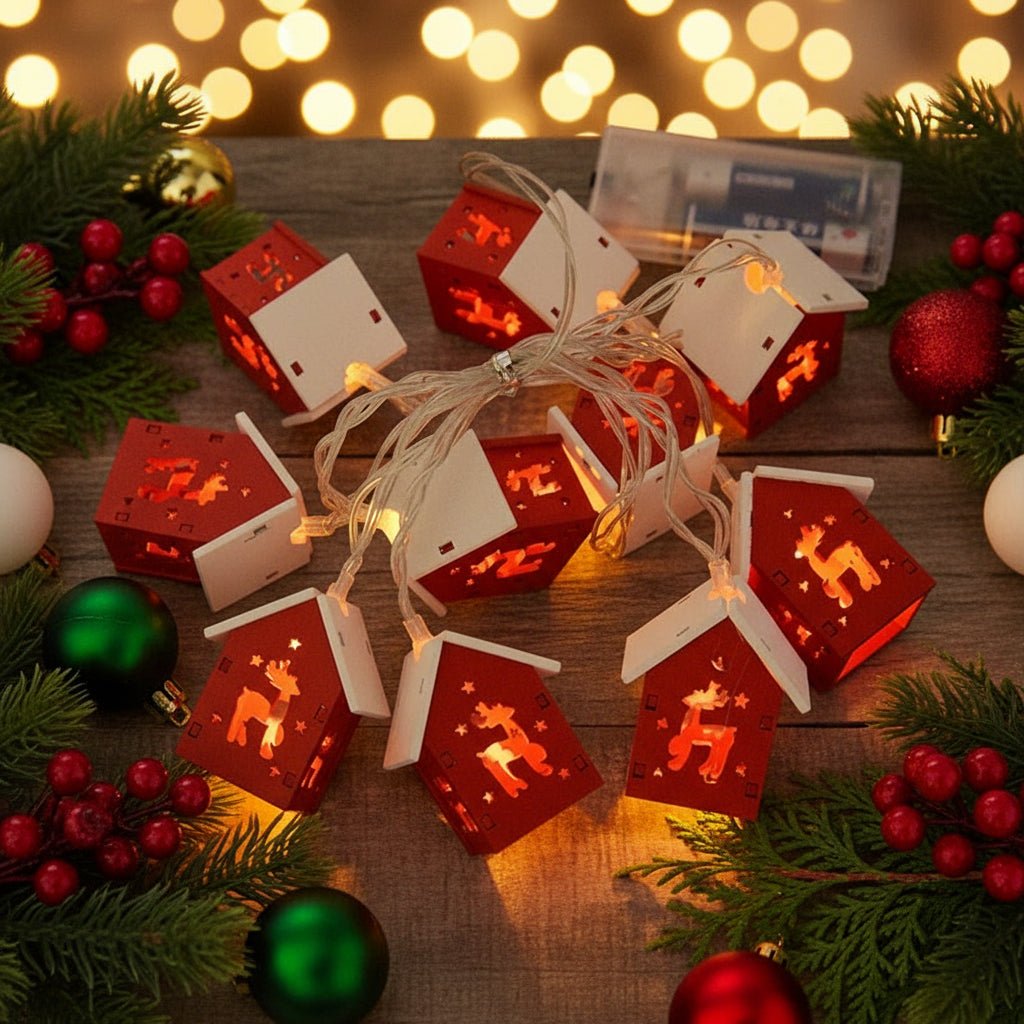 Red house LED fairy lights with reindeer cut-outs on wood table