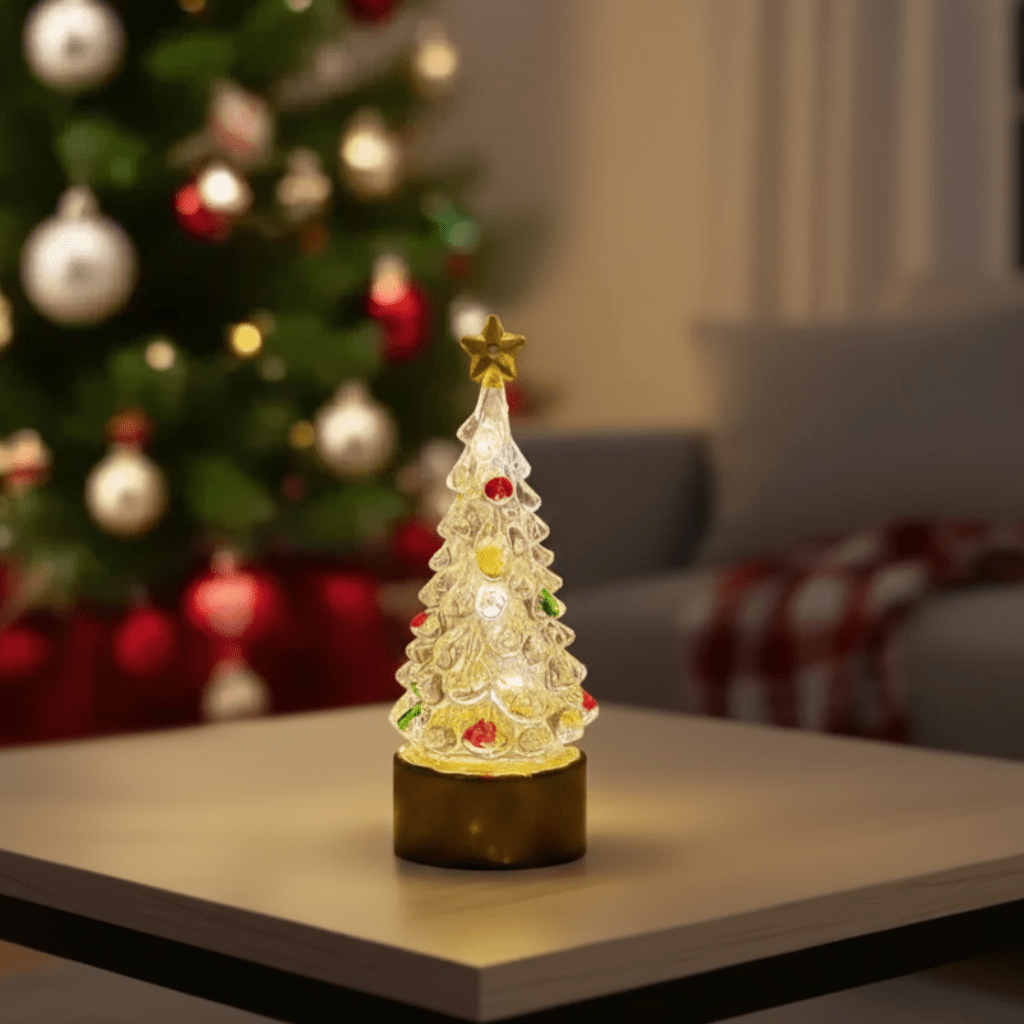 Small Christmas tree with lights glowing on a living room table