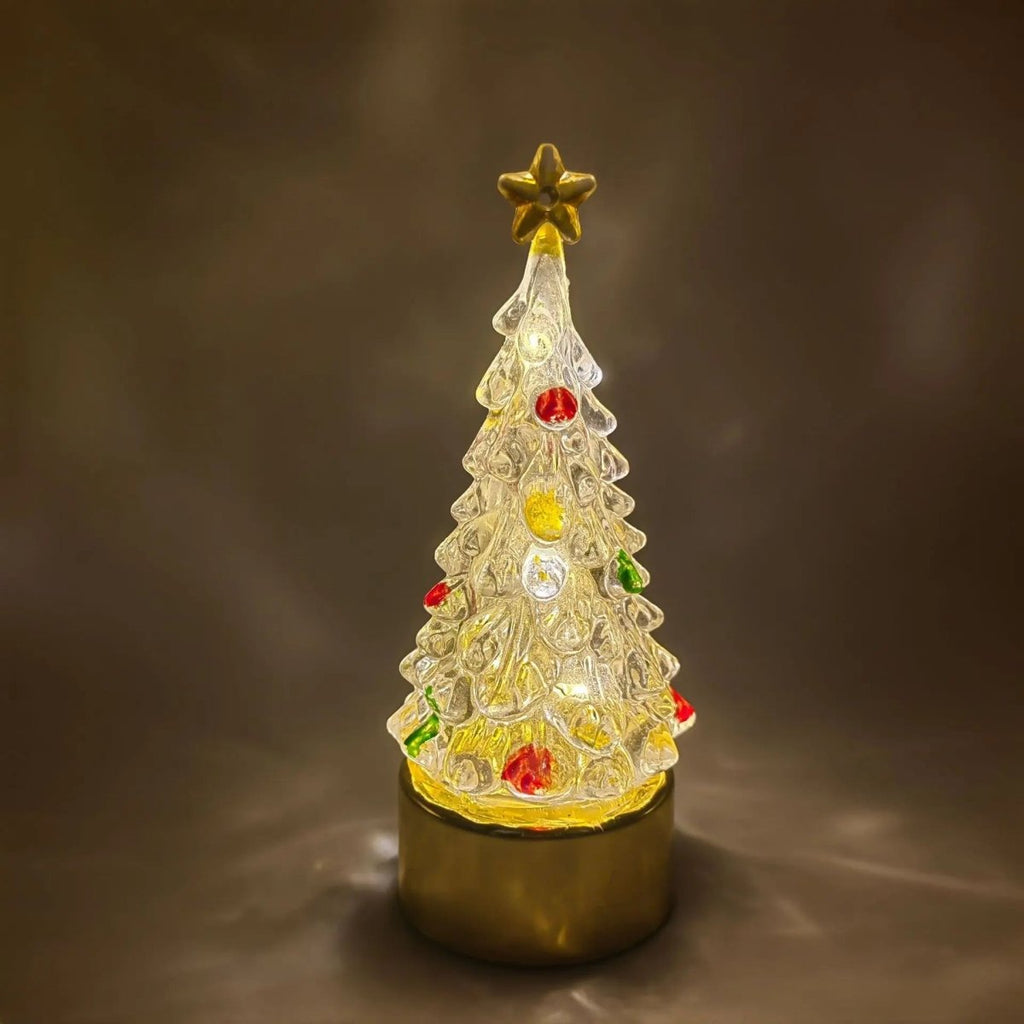 Lit Christmas tree lamp glowing warm against a dark background