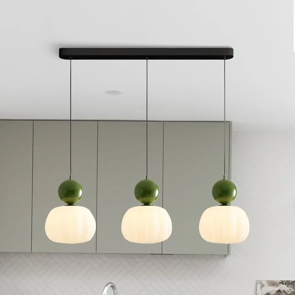 Three Olive Green pendant lamps hanging in a row
