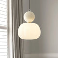 Cream art deco lamp hanging beside a linen curtain