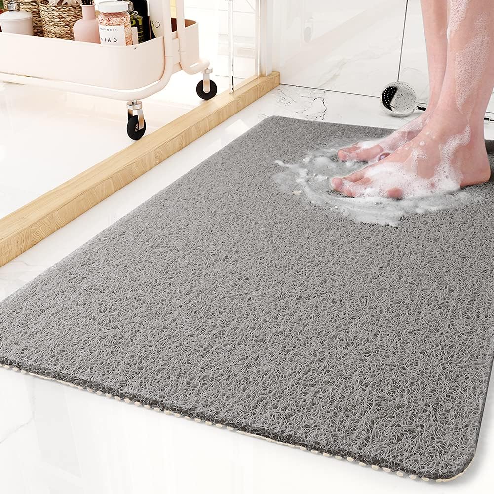 Gray quick-drain shower mat on a marble bathroom floor
