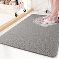 Gray quick-drain shower mat on a marble bathroom floor