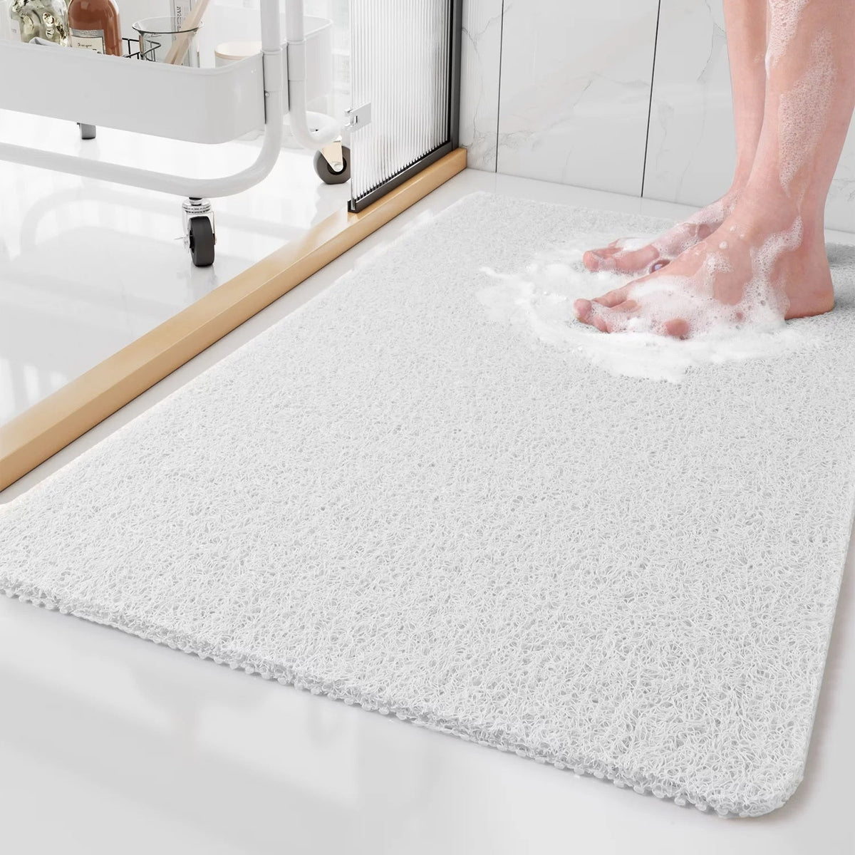 White shower mat with drainage weave on bathroom floor