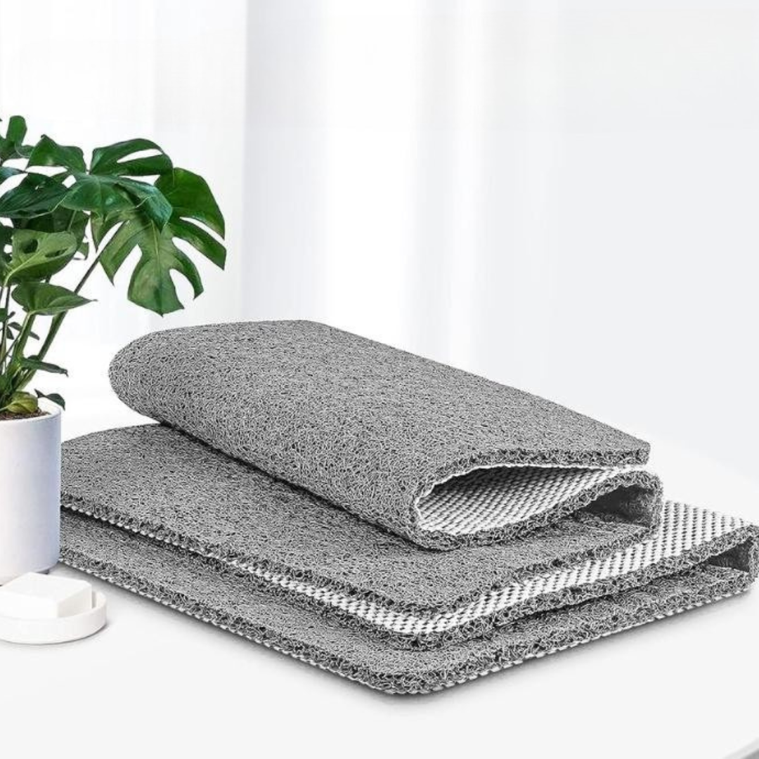 Folded gray shower mat showing its grippy underside