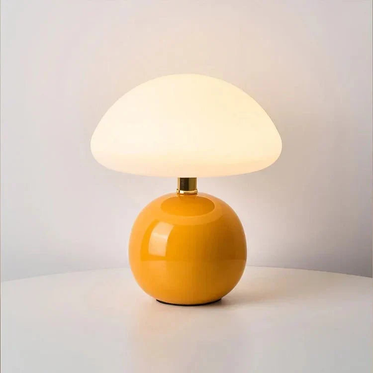 Soft white dome shade glowing on a compact ceramic base