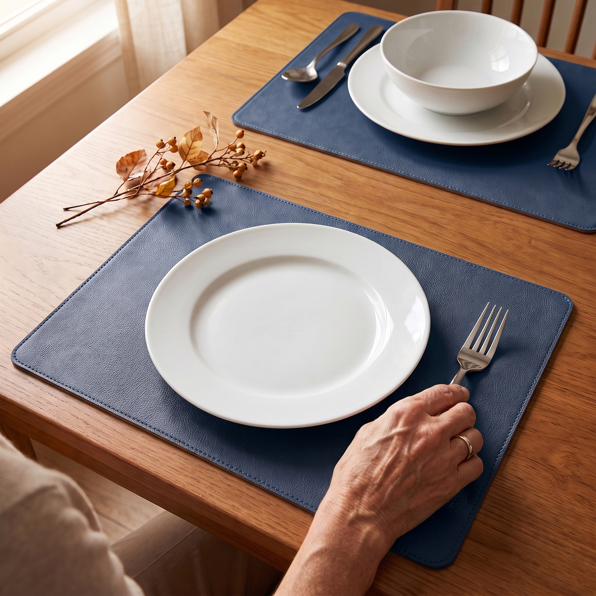 Blue faux leather placemats on a warm wood dining table