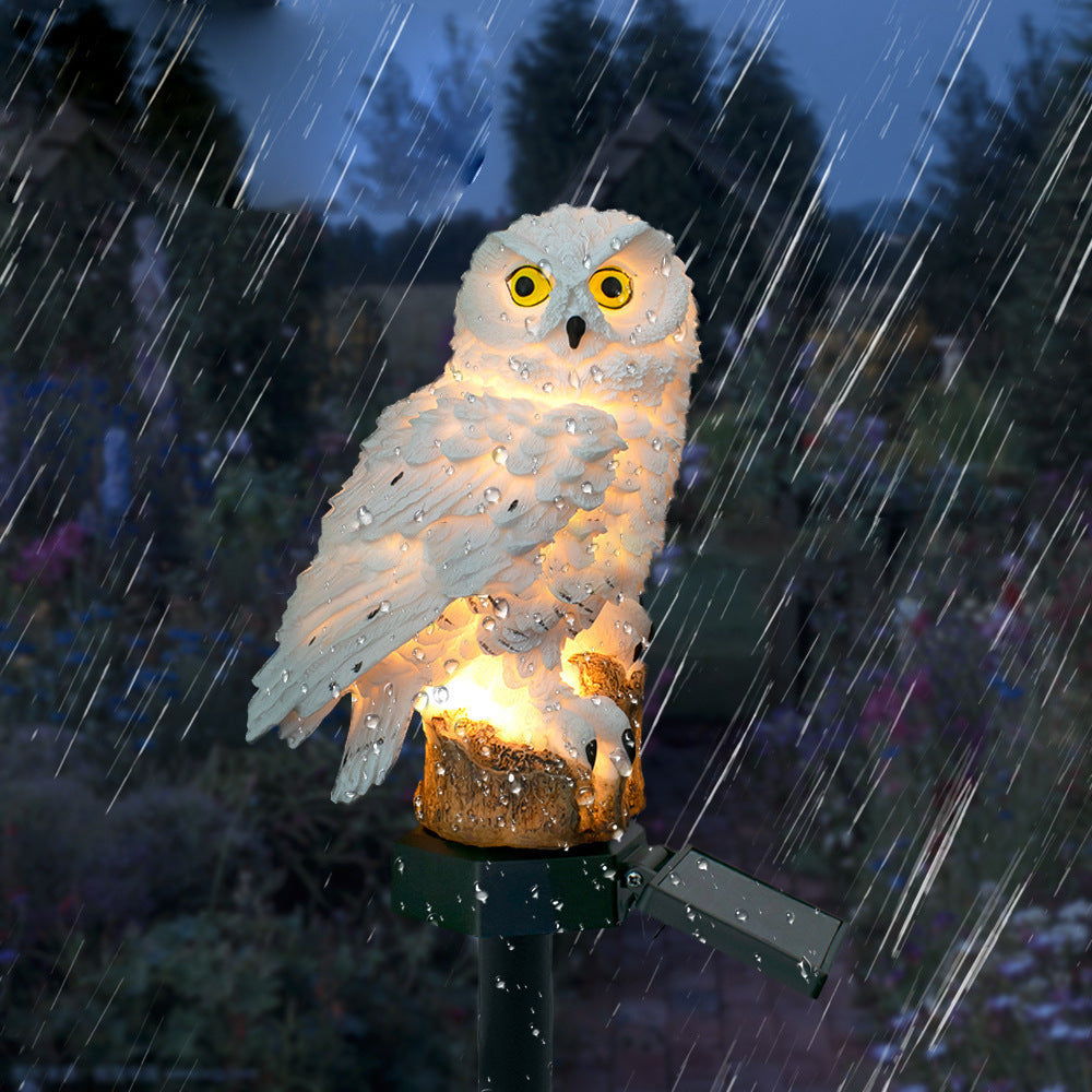 Glowing owl garden light standing in the rain