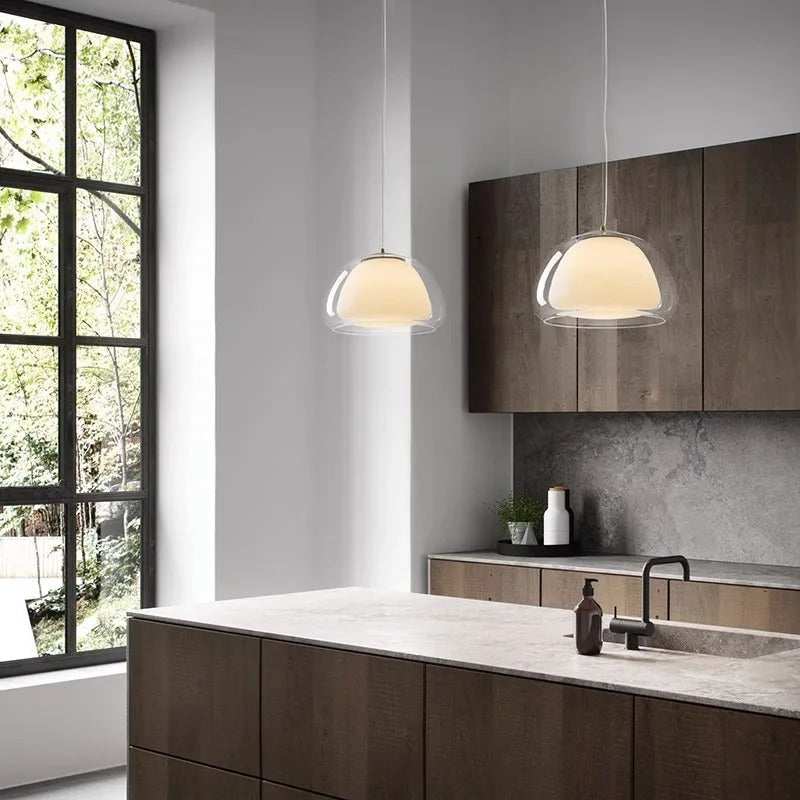 Glass globe pendant light over dining table