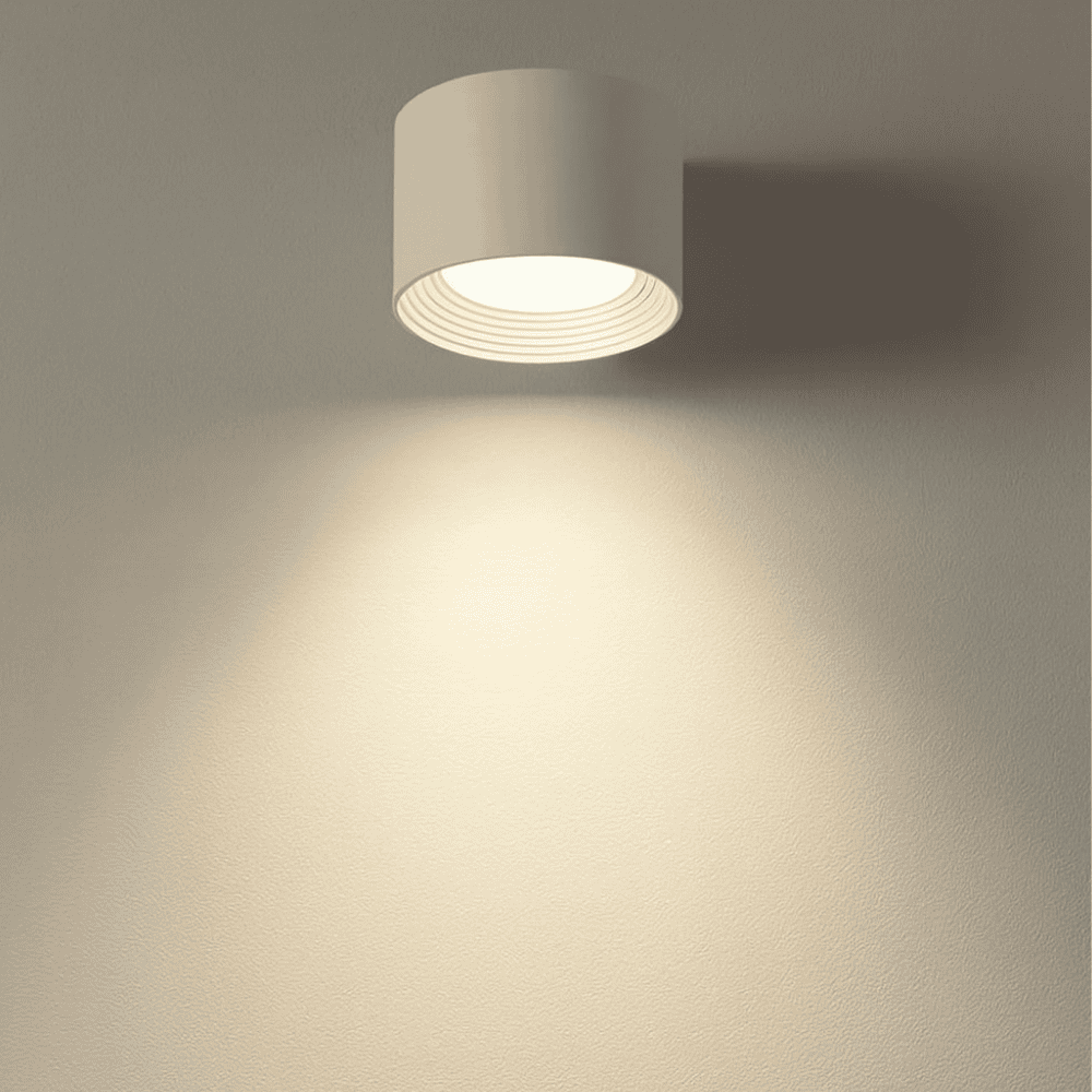 White LED wall light shining a warm beam down the wall