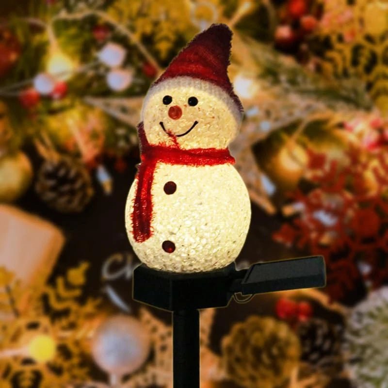 Snowman stake light glowing warm white with red knitted hat