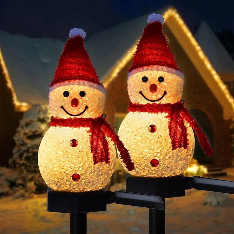 Two snowman outdoor Christmas lights glowing at night