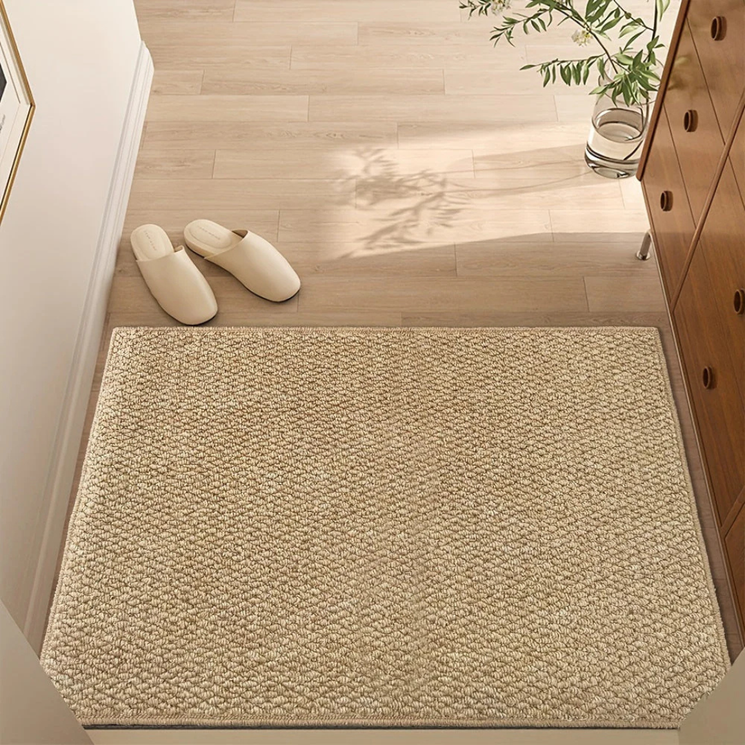 Natural woven entry mat in a bright hallway with slippers