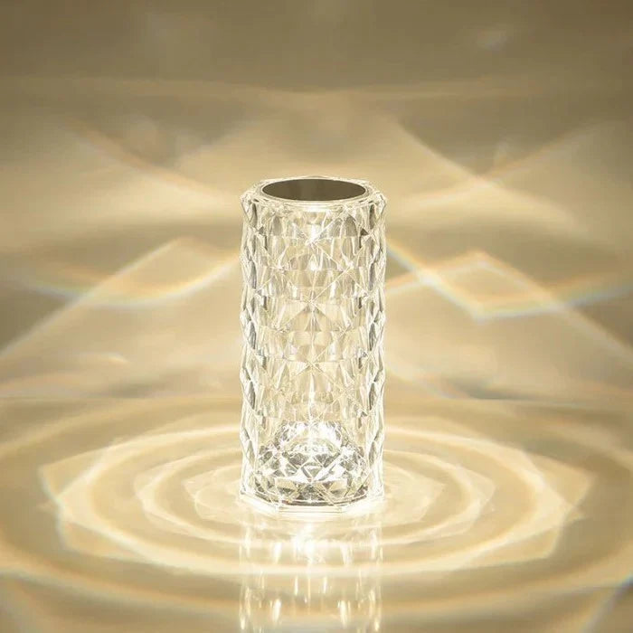 Small faceted lamp casting light patterns on a wall
