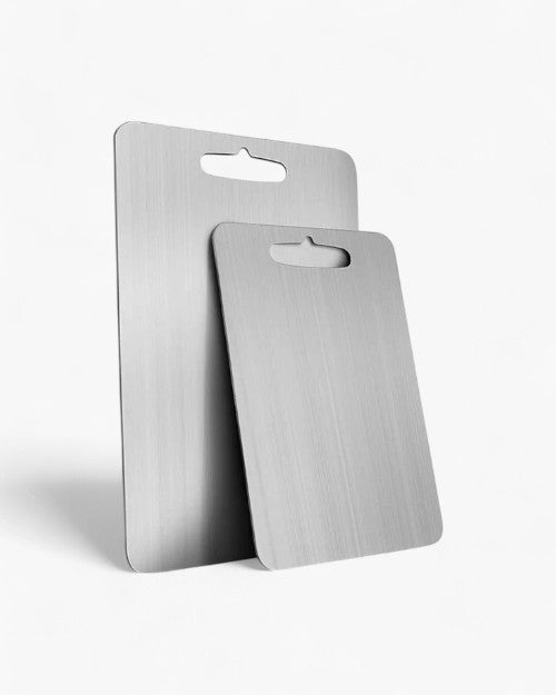 Two brushed stainless steel cutting boards standing upright